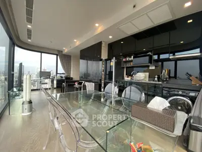 Luxurious modern kitchen and dining area with stunning city view and sleek glass table.