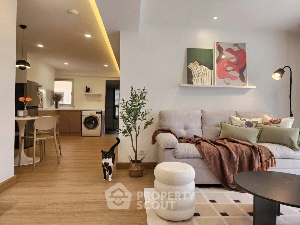 Stylish modern living room with cozy seating and open kitchen layout