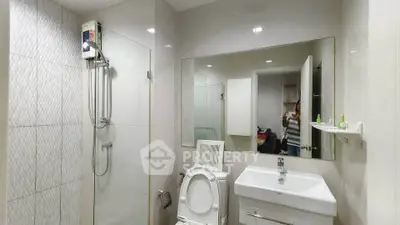 Modern bathroom with sleek fixtures and spacious shower area.