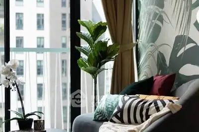 Stylish living room with large windows and lush plant decor
