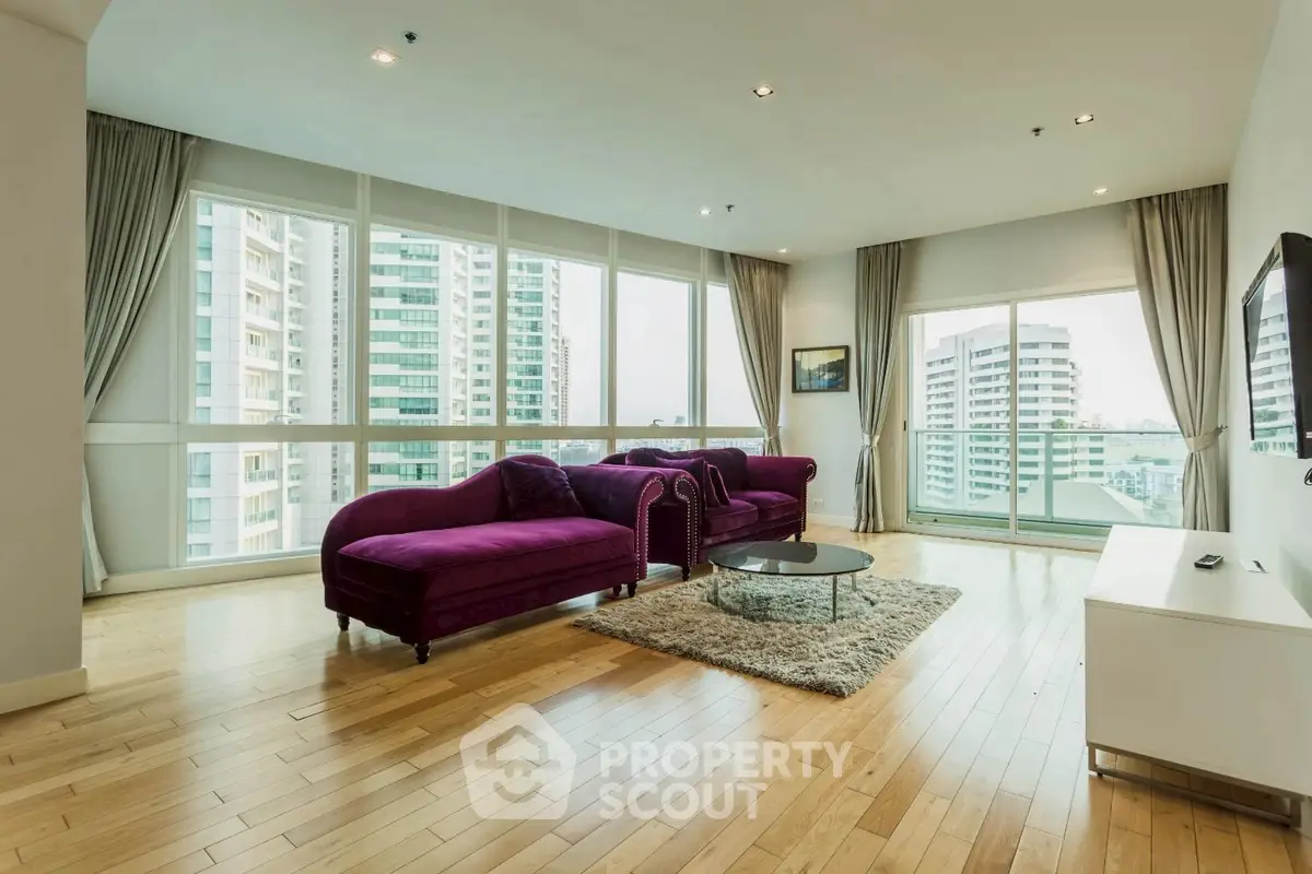 Spacious modern living room with large windows and city view
