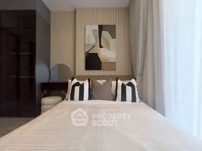 Modern bedroom with stylish decor and abstract art, featuring a cozy bed and elegant design.