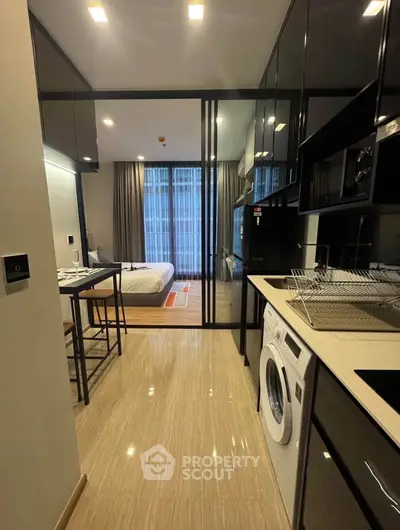 Modern apartment interior with sleek kitchen and cozy bedroom view