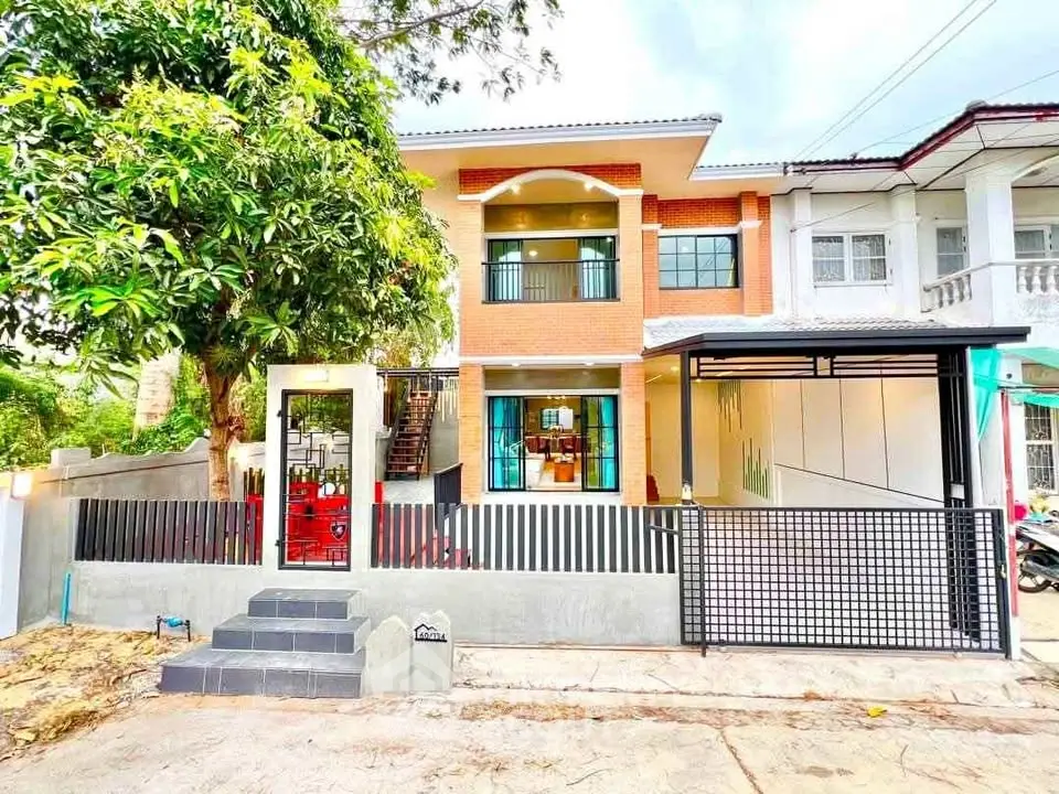 Charming two-story house with modern facade and spacious driveway in a serene neighborhood.