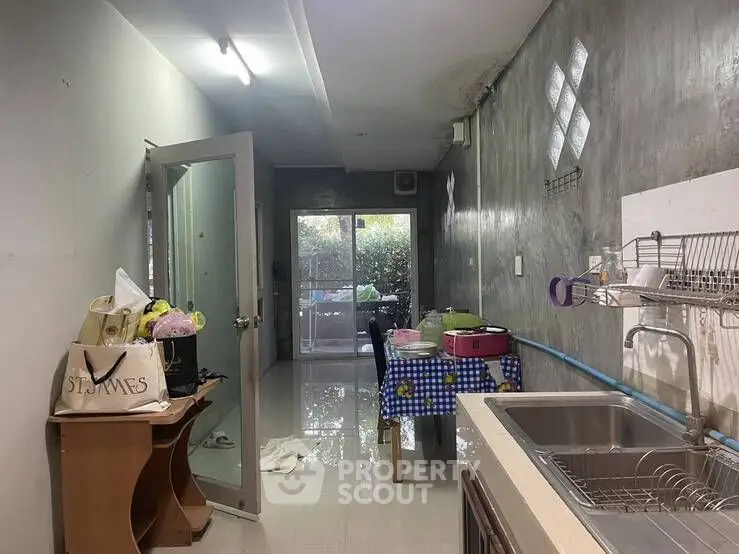 Cozy kitchen with open layout and garden view, featuring modern sink and dining area.