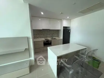 Modern kitchen with sleek cabinetry and island in contemporary apartment