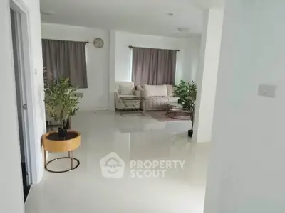 Spacious living room with modern decor and natural light