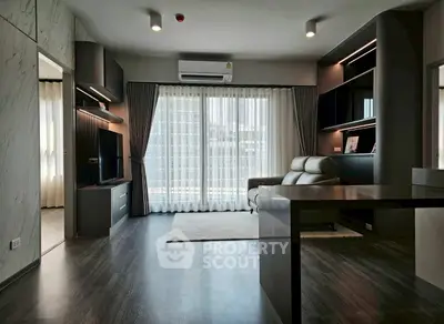 Modern living room with sleek design, large windows, and stylish furniture in a high-rise apartment.