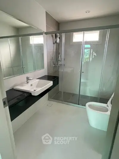 Modern bathroom with glass shower and sleek fixtures