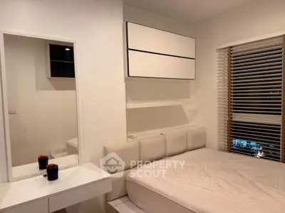 Modern bedroom with sleek white furniture and large window blinds