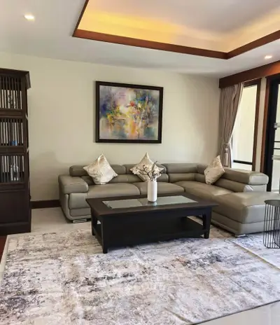 Elegant living room with modern sectional sofa and abstract art, perfect for stylish urban living.