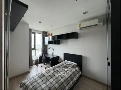 Modern bedroom with ample natural light, sleek furniture, and a cozy workspace, perfect for urban living.