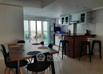 Modern open kitchen with dining area and stylish brick bar counter