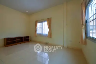 Spacious empty room with tiled floor and large windows, perfect for customization.
