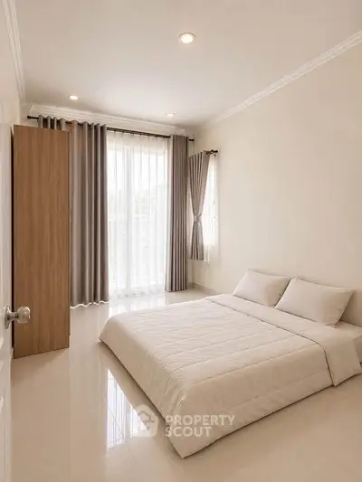 Spacious minimalist bedroom with natural light and modern decor