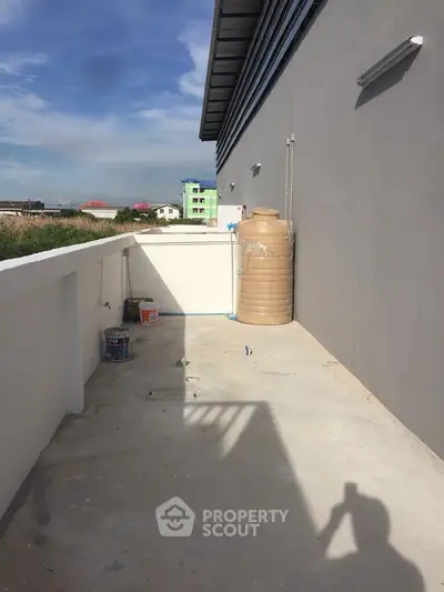 Spacious outdoor area with water tank and clear sky view