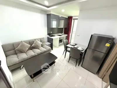 Modern open-plan living room and kitchen with sleek furniture and appliances.