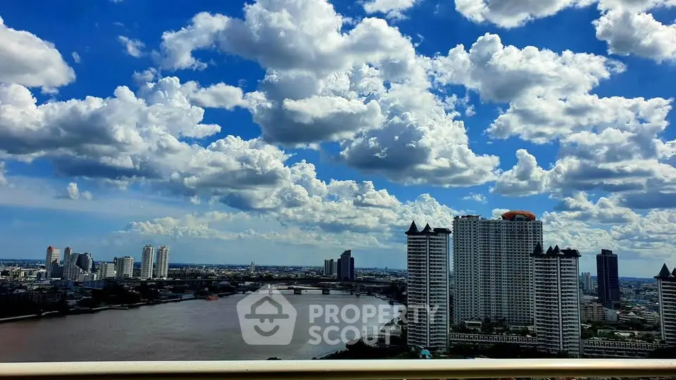Stunning cityscape view with river and skyscrapers under a vibrant blue sky.