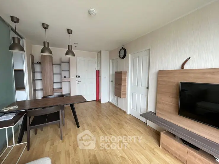 Modern living room with wooden flooring and stylish furniture, perfect for cozy gatherings.