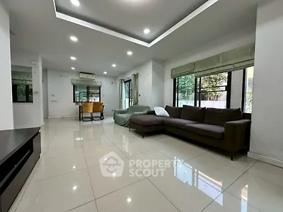 Spacious modern living room with large windows and sleek tile flooring