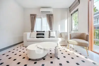 Bright and stylish living room with modern furniture and large windows.