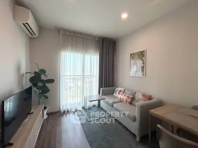 Modern living room with stylish decor, large window, and cozy seating area.