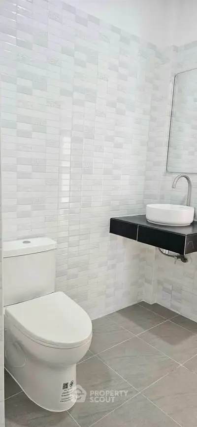 Modern bathroom with sleek white tiles and contemporary fixtures