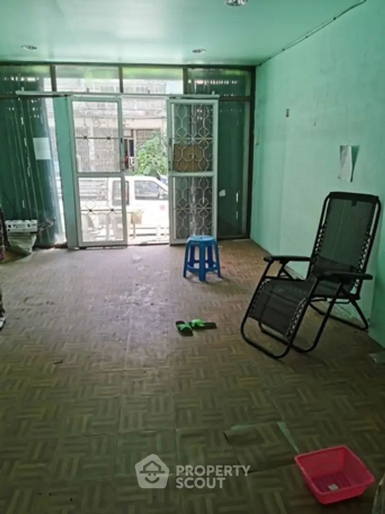 Spacious empty room with large windows and minimal furniture, ideal for customization.