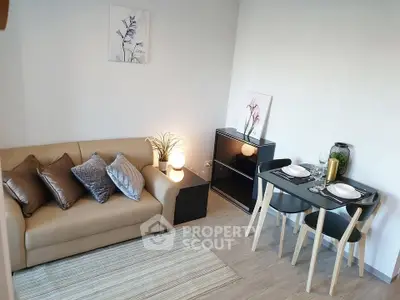 Cozy living room with modern decor and dining area, perfect for urban living.