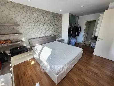 Spacious bedroom with modern decor and ample natural light