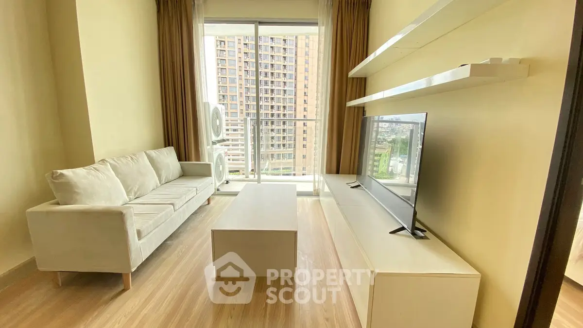 Modern living room with sleek furniture and city view from large window