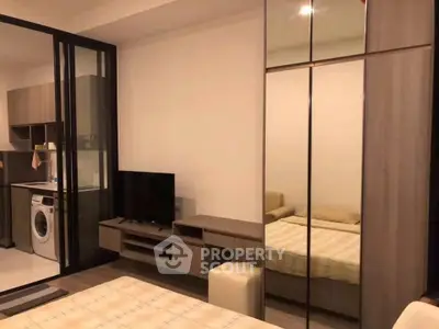 Modern studio apartment with mirrored wardrobe and in-unit washing machine