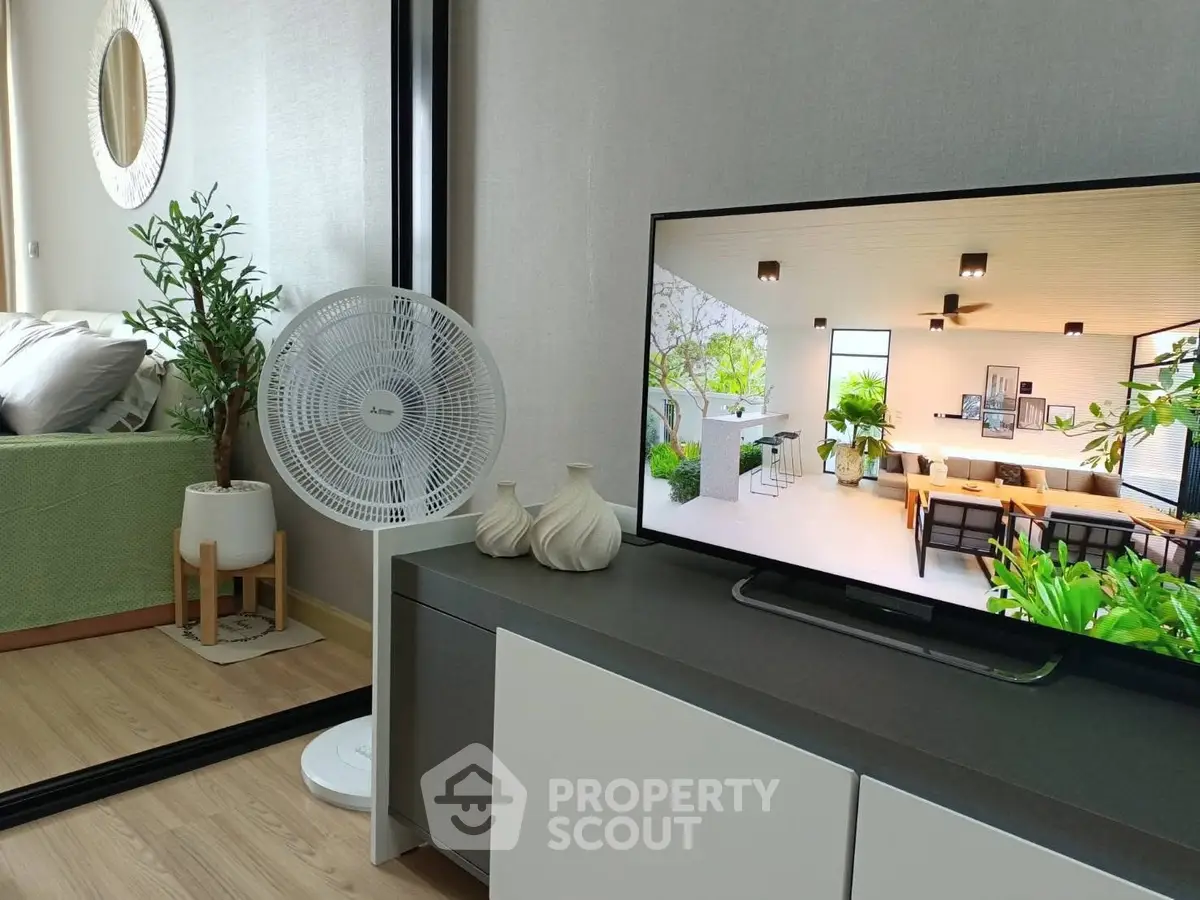 Modern living room with stylish decor and a large TV displaying a beautiful interior design.