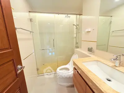 Modern bathroom with glass shower and marble countertop