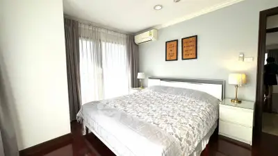 Spacious bedroom with elegant decor and natural light in modern apartment