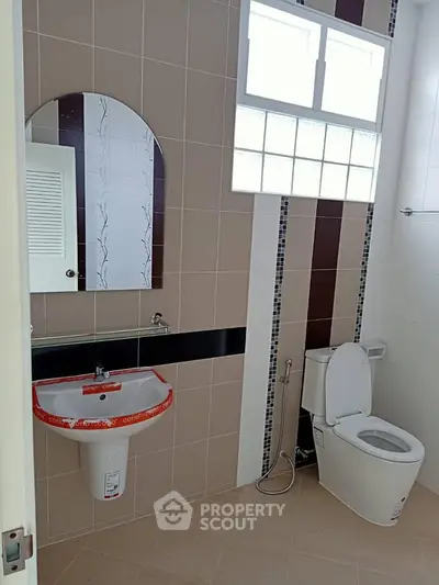 Modern bathroom with stylish sink and toilet in a well-lit space.
