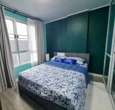 Cozy bedroom with modern decor and large window for natural light
