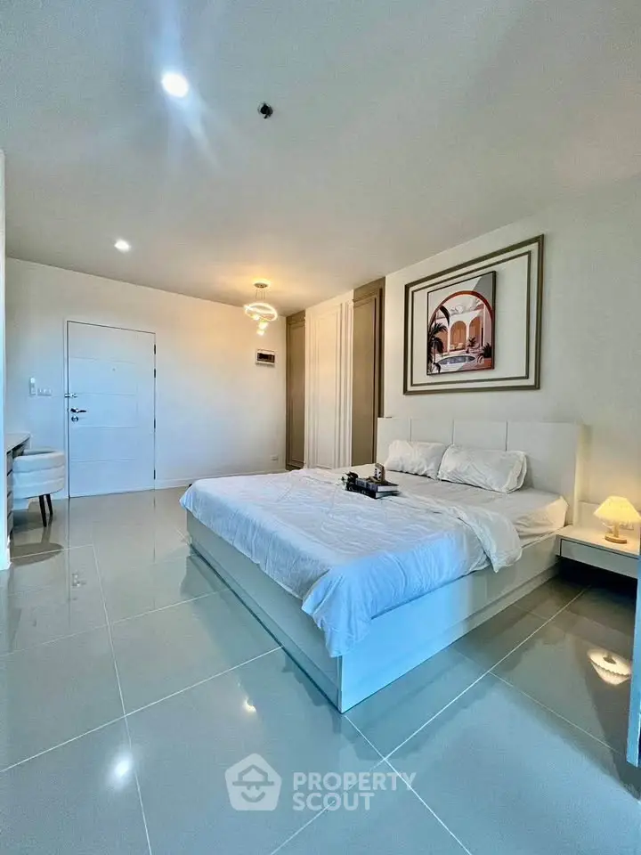 Spacious modern bedroom with elegant decor and glossy tiled flooring