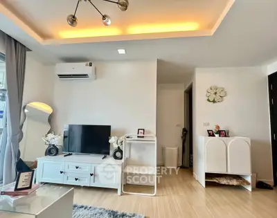Modern living room with stylish decor and ambient lighting, featuring a sleek TV setup and elegant furnishings.