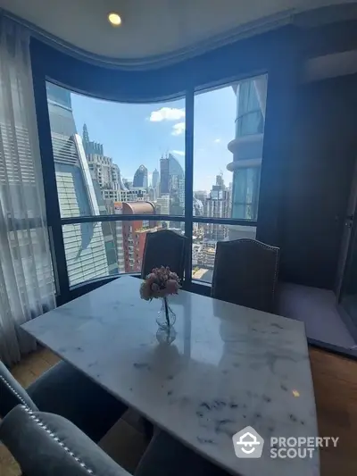 Luxurious dining area with stunning city view from high-rise apartment