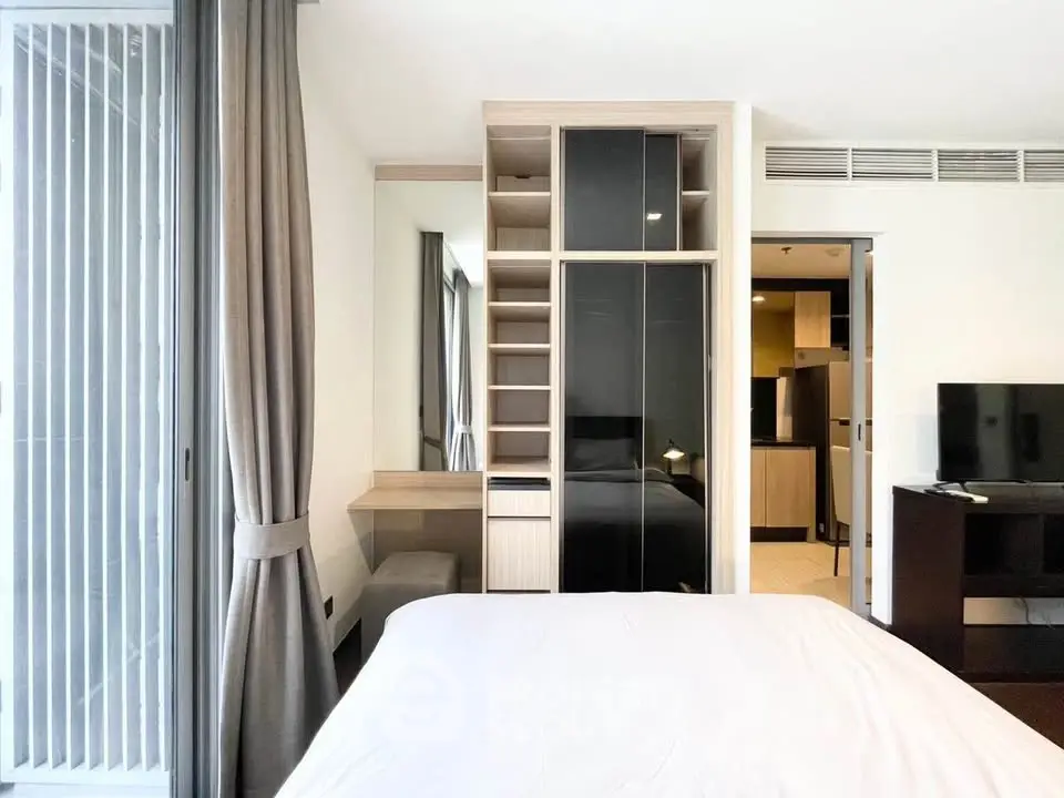 Modern bedroom with sleek wardrobe and natural light