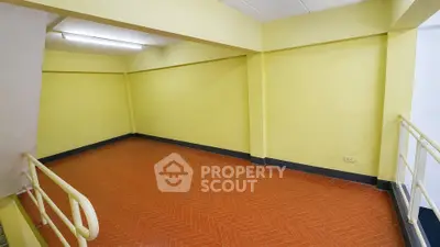 Spacious empty room with vibrant yellow walls and terracotta flooring, ideal for creative customization.