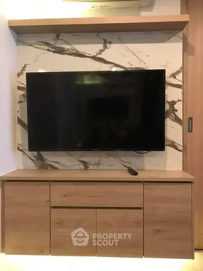 Modern living room with sleek TV unit and marble accent wall