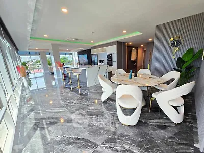 Luxurious open-plan living room with modern kitchen and stunning city views.