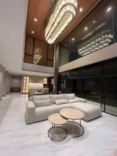 Luxurious modern living room with high ceilings and elegant chandelier