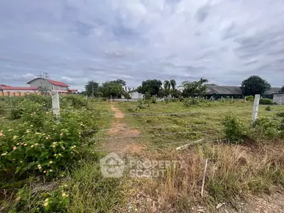 Expansive plot of land with lush greenery and potential for development.