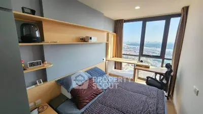 Modern bedroom with large window offering stunning city view, featuring sleek furniture and stylish decor.
