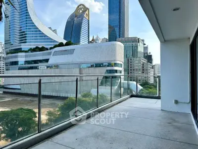 Spacious balcony with stunning cityscape view in modern urban setting.