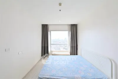 Bright bedroom with large window offering stunning city view, minimalist decor and ample natural light.
