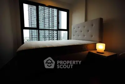 Modern bedroom with large window offering stunning cityscape views, featuring a cozy bed and ambient lighting.